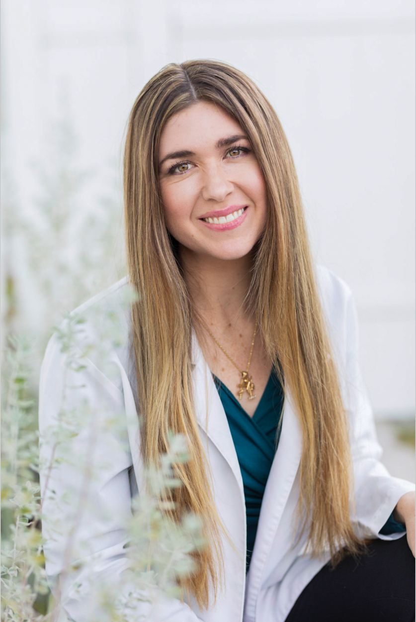 doctor in white coat with foliage